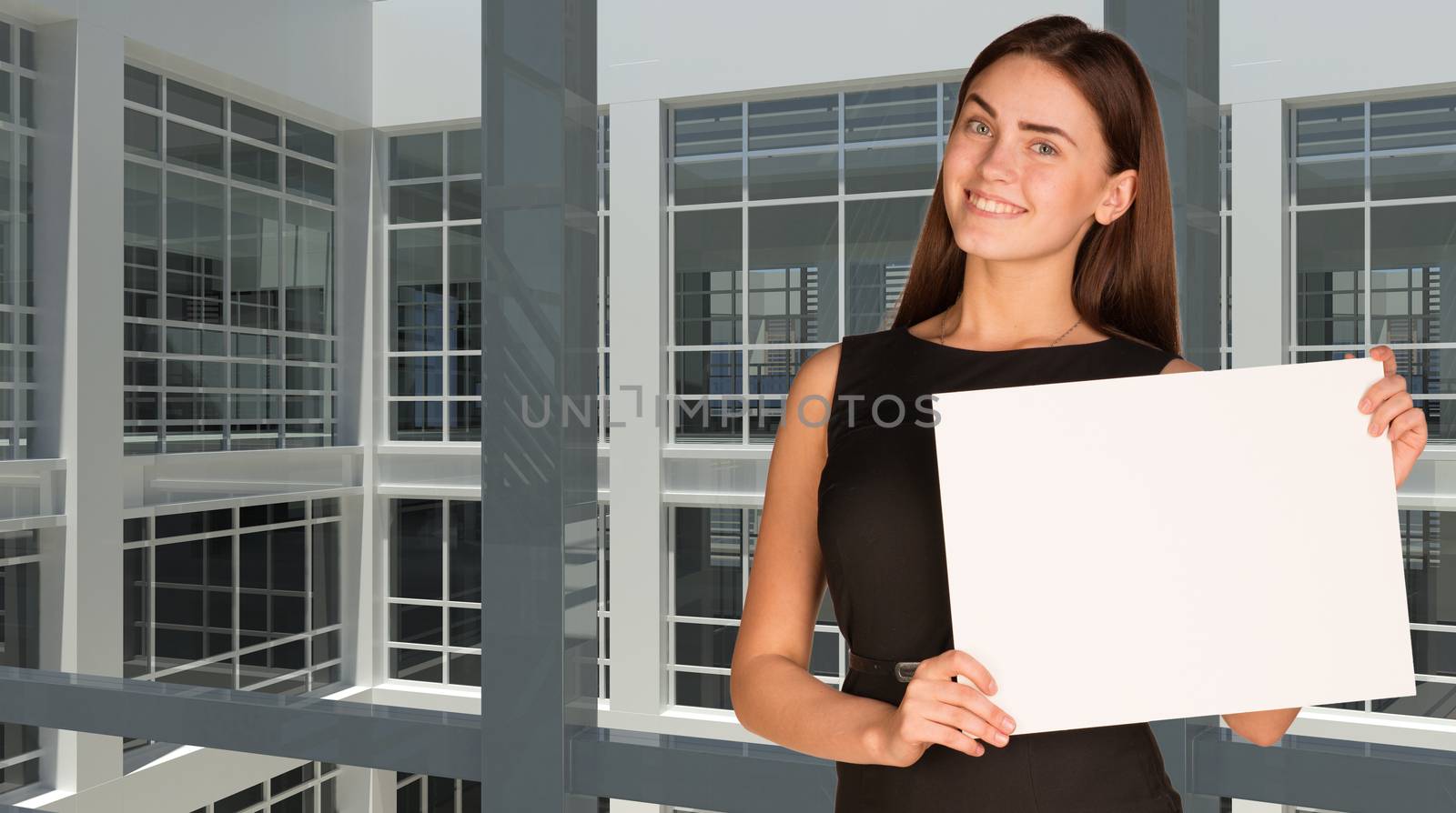 Businesswoman holding paper sheet by cherezoff