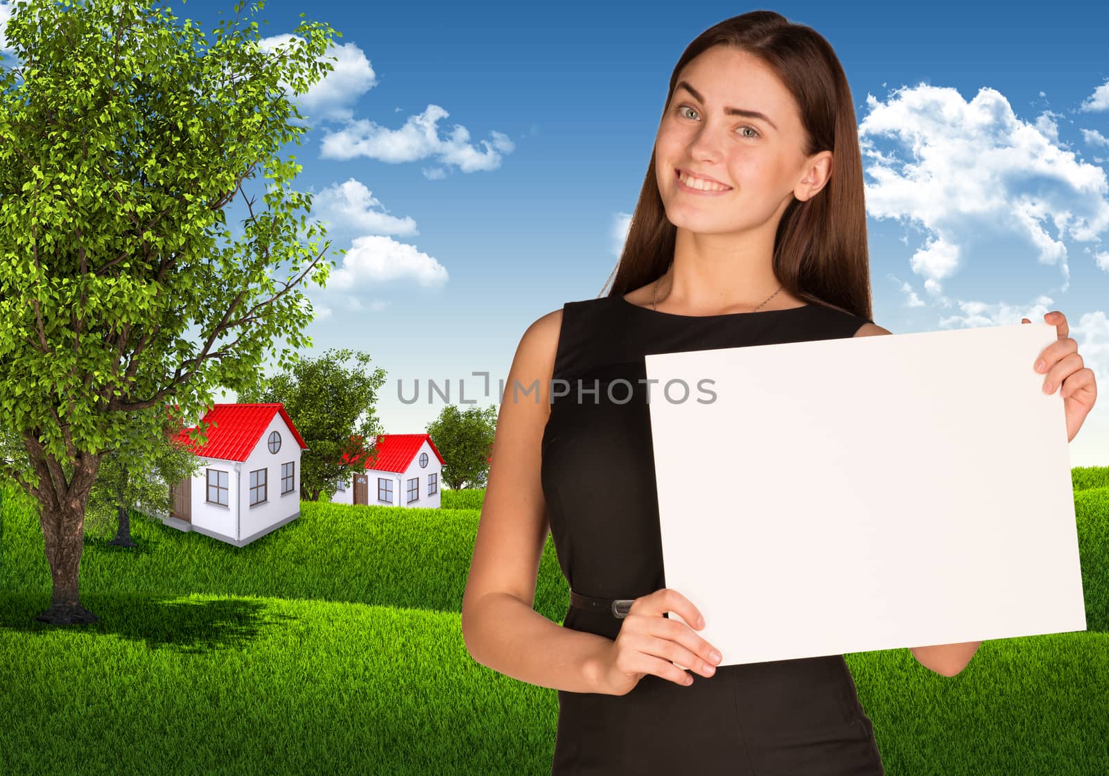 Businesswoman holding paper sheet. Blue sky, green grass and town as backdrop