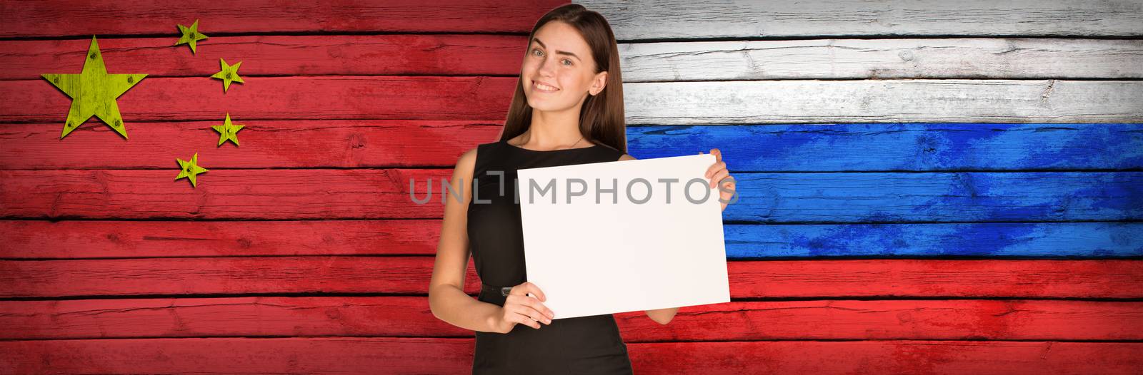 Businesswoman holding paper sheet. China and Russian flags as backdrop