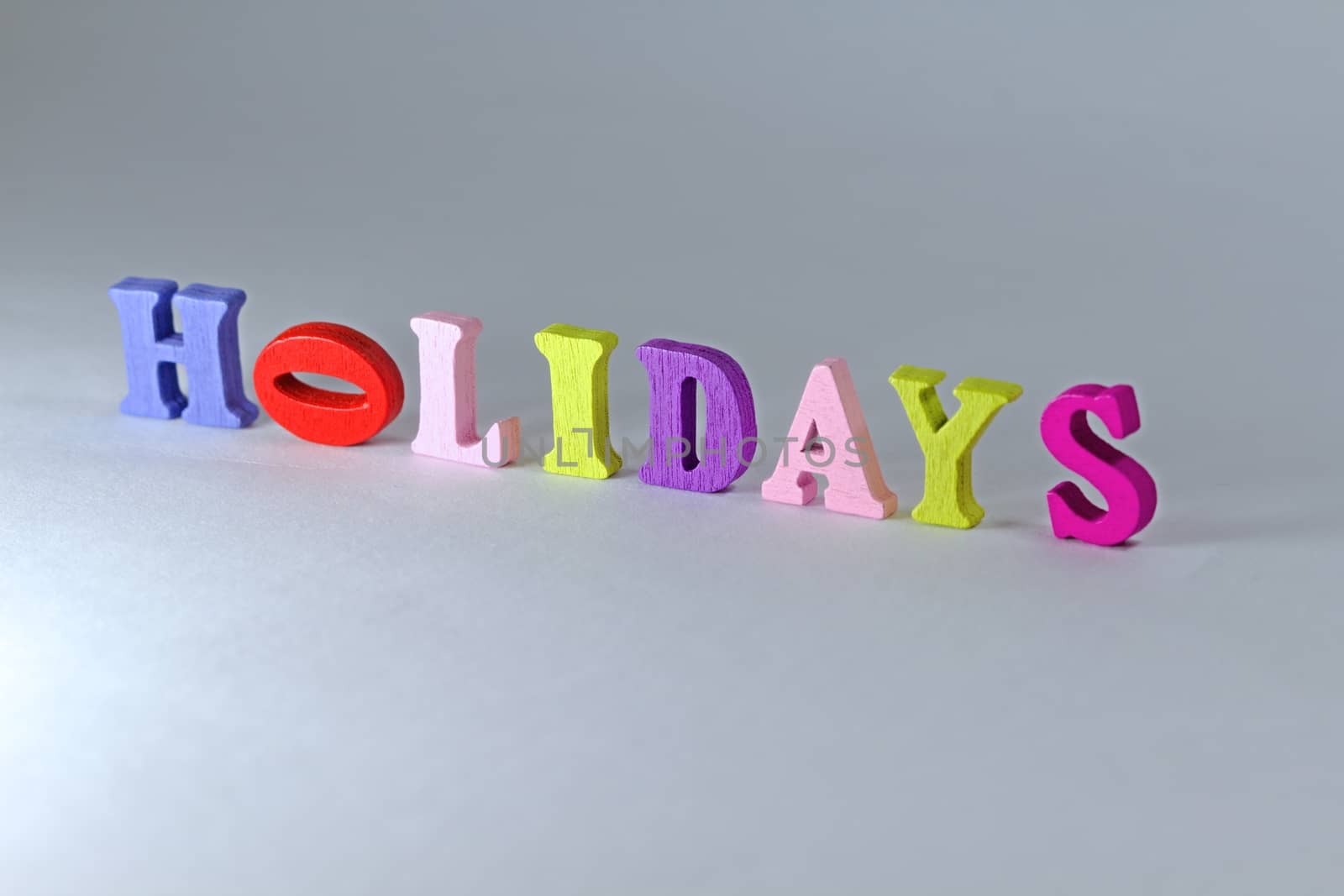 Photo shows detail of holidays sign on white background.