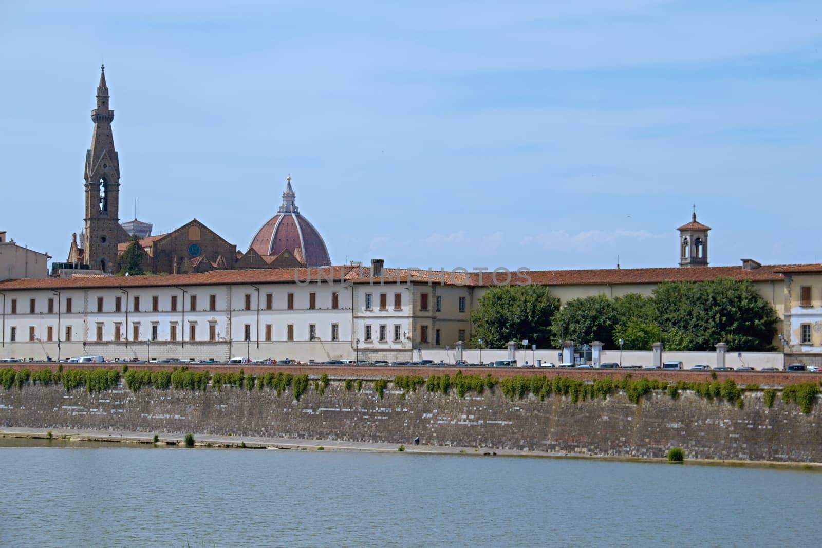 Photo shows a general view onto the city river bank with its houses.