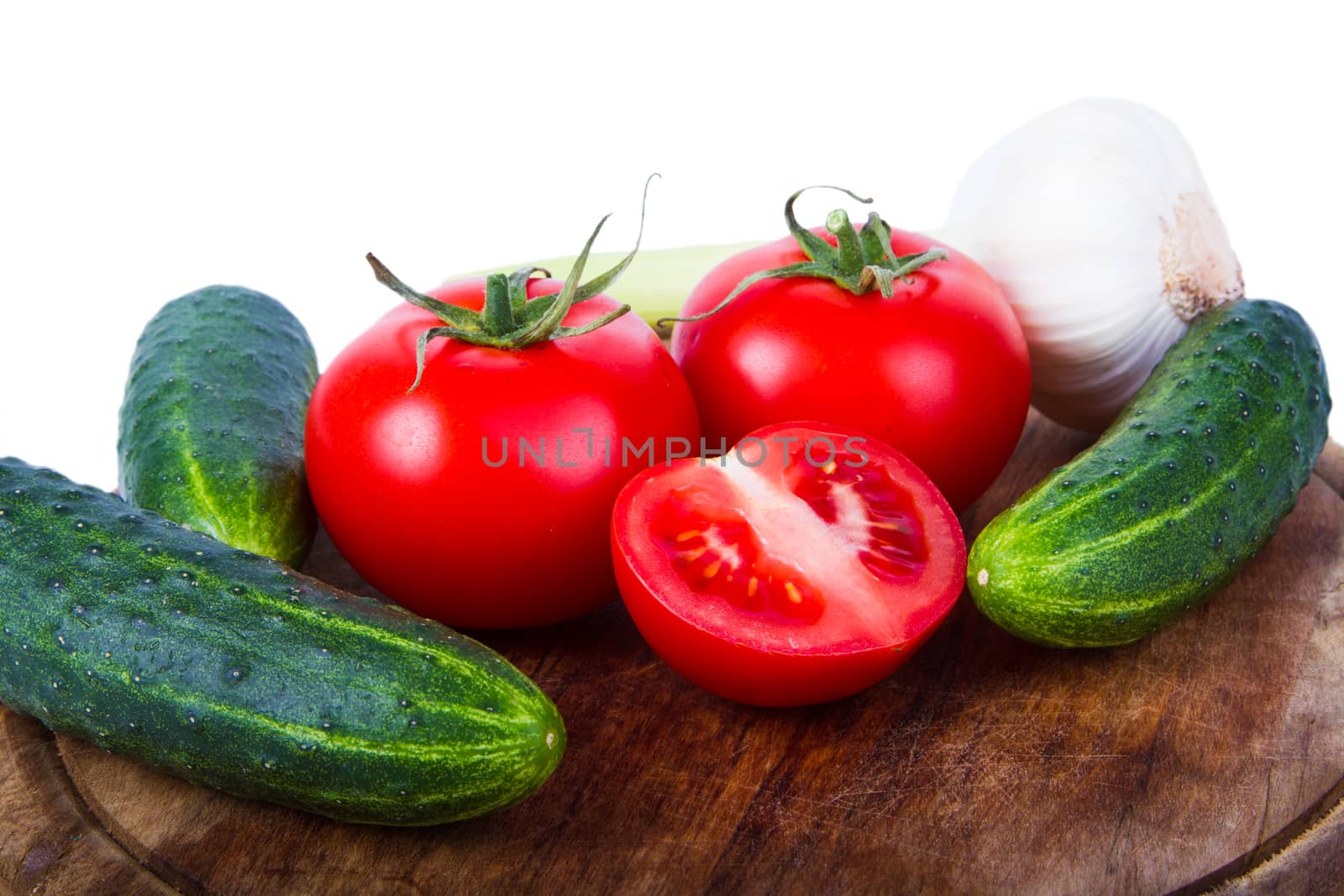 Cucumbers, tomatoes and garlic isolated on white