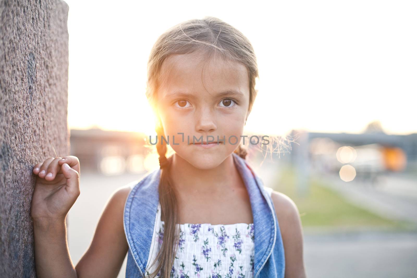 Happy young girl in a city by Kor