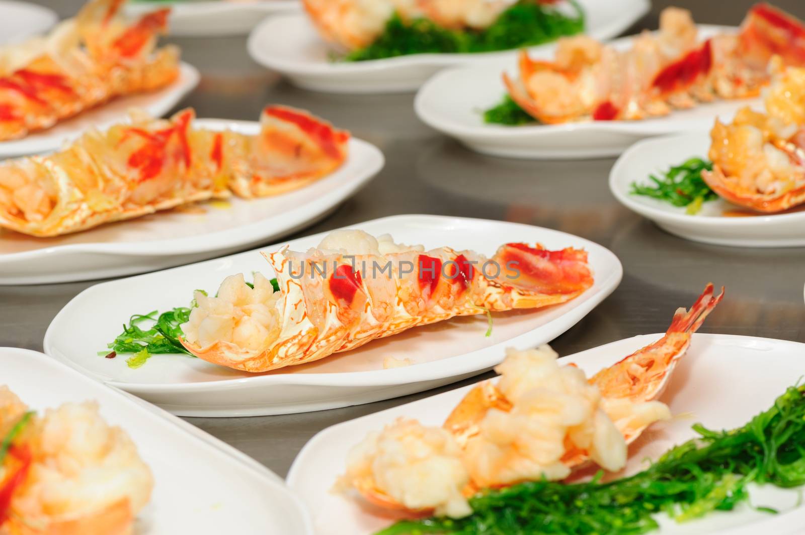 Prepared lobster and sea weed on plates