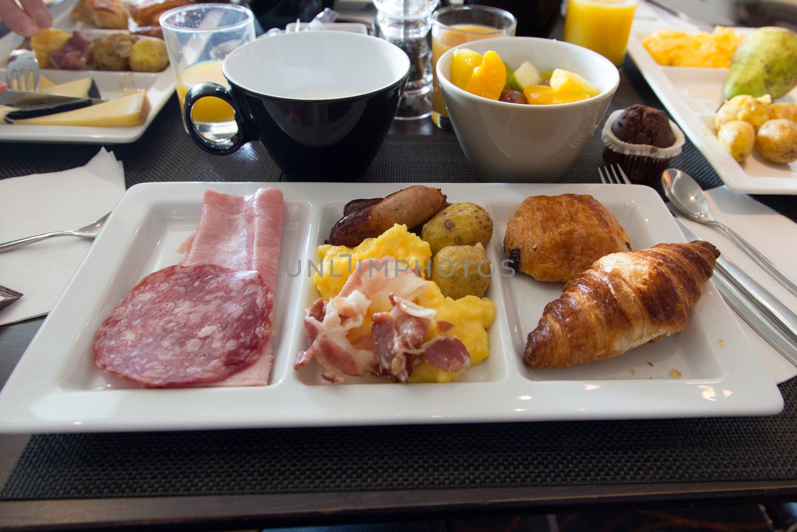 Napkin with extensive breakfast - meat - egg - pastry