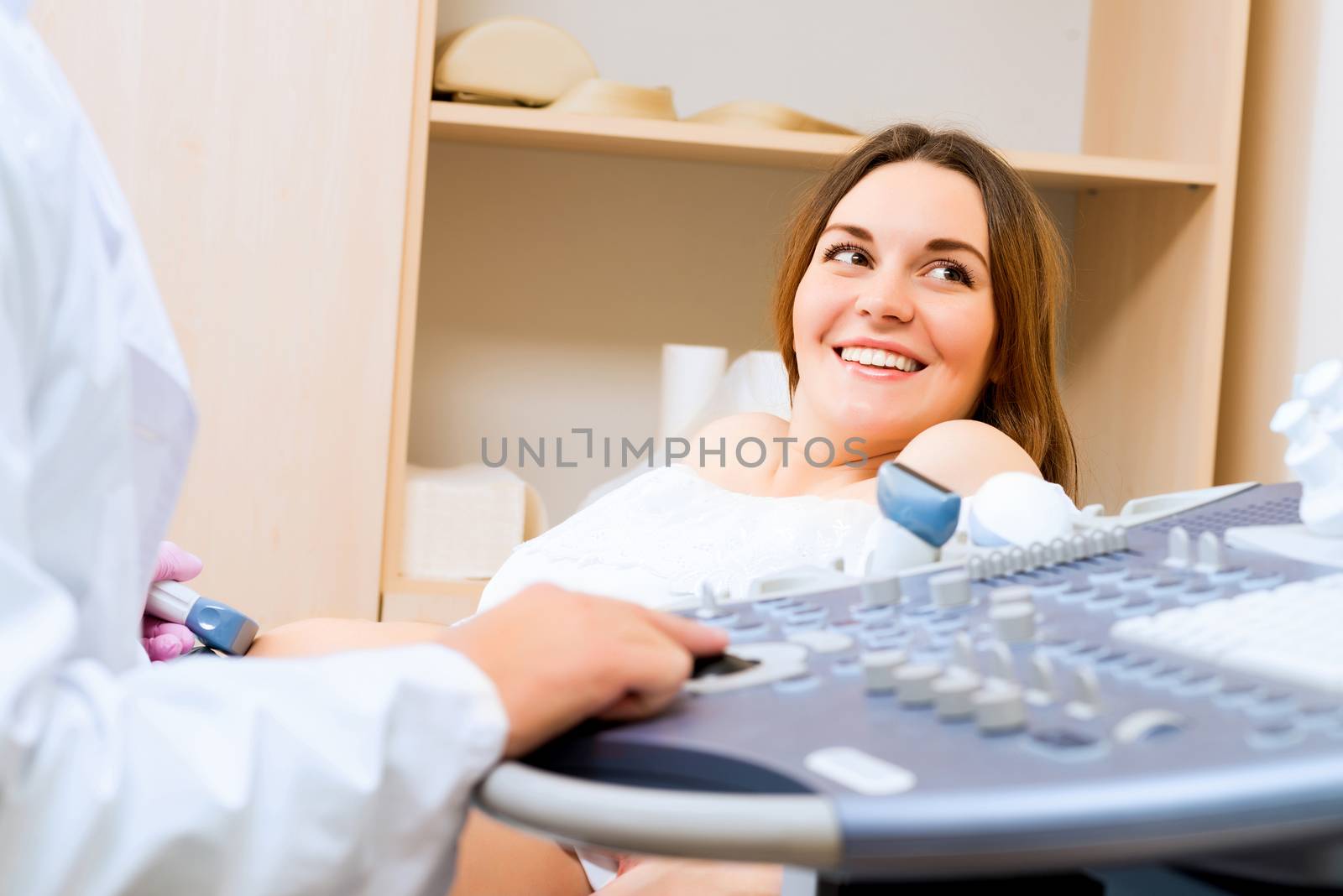 Young attractive pregnant woman on reception at the doctor, health check