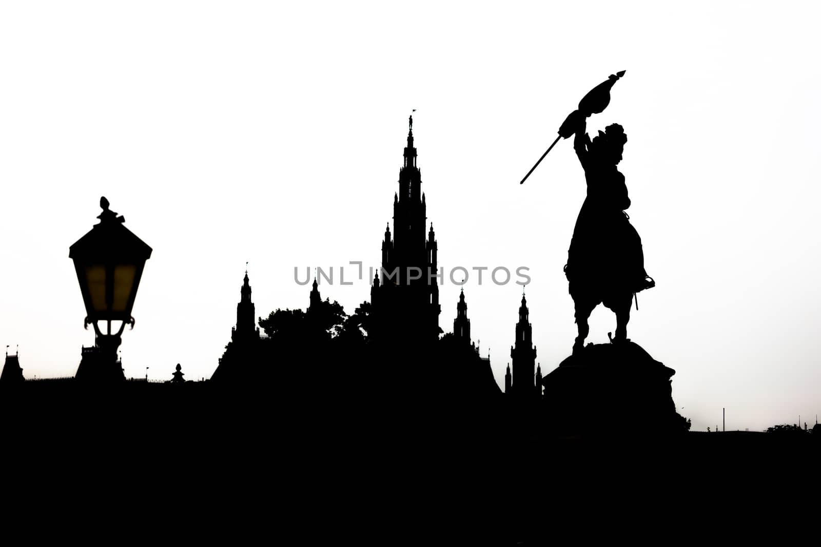 Vienna cityscape silhouette with monument dedicated to Archduke Charles of Austria (Erzherzog Karl) ridding a horse and the city hall (Rathause) in Vienna, Austria.