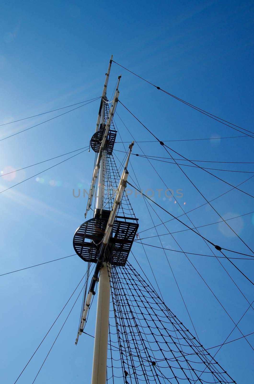 Sailboat Mast and Ropes isolated on Blue Sunny Sky background Outdoors