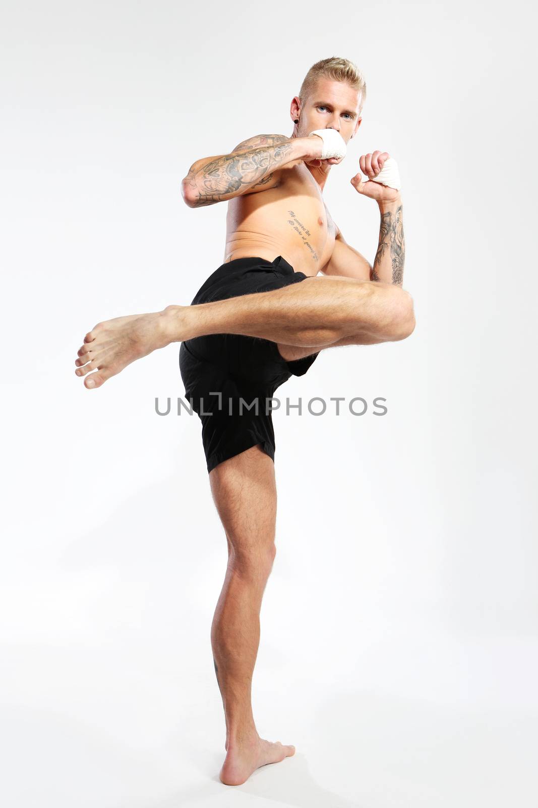 Attractive young caucasian man training martial arts
