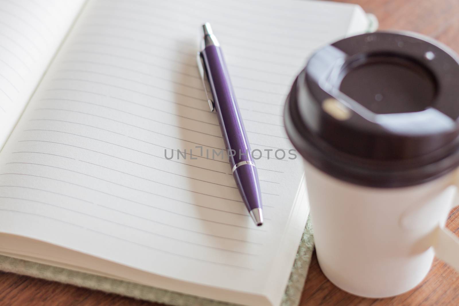 Pen and notebook with coffee cup, stock photo
