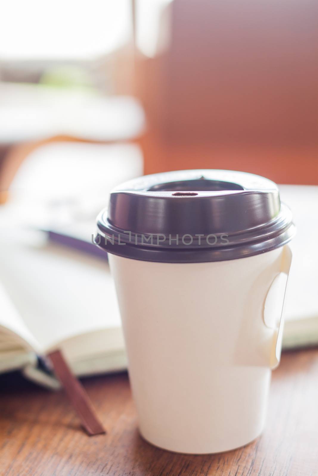 Closed up coffee cup on wooden table by punsayaporn