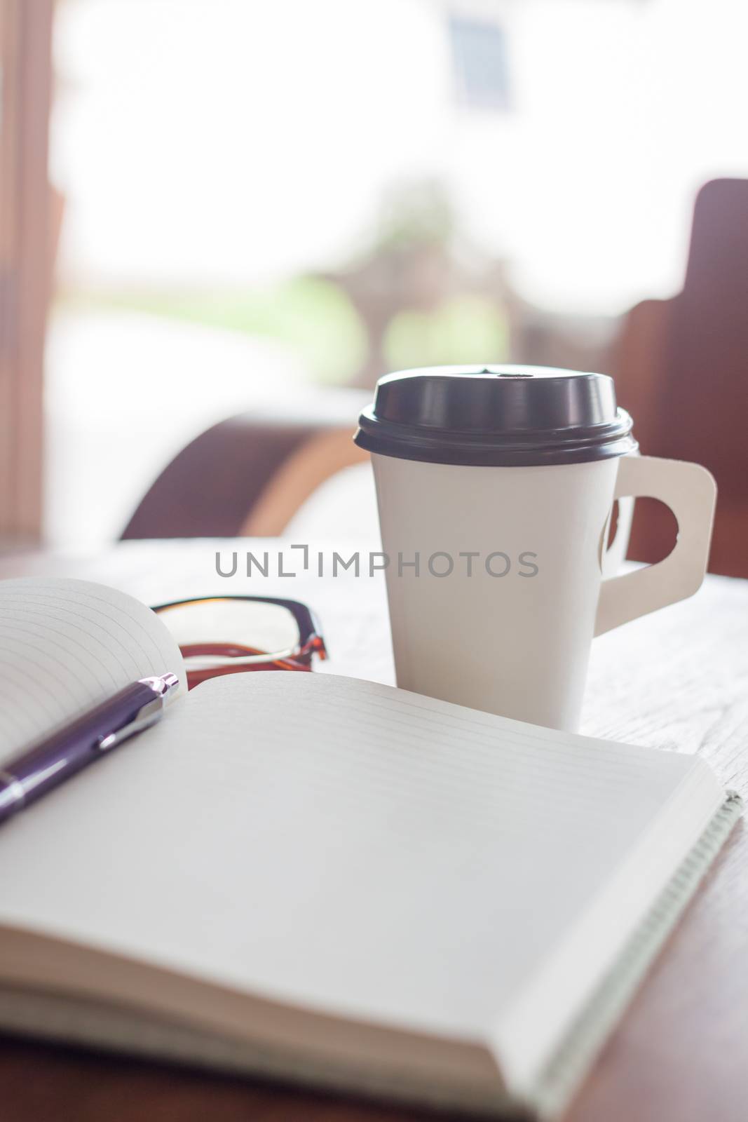 Notebook and pen with coffee cup, stock photo