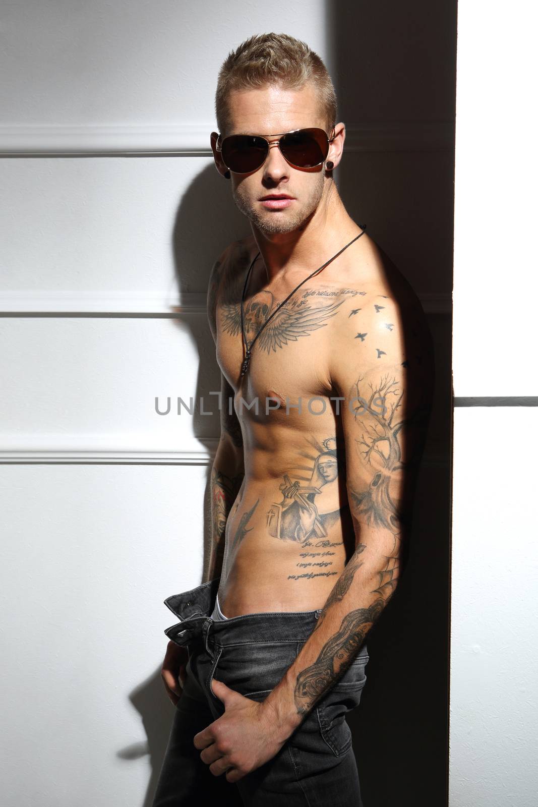 Handsome tattooed Caucasian man without a shirt