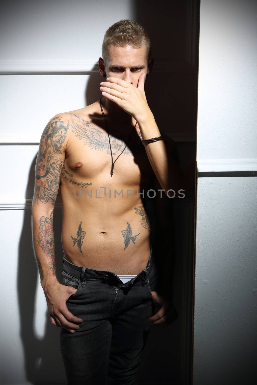 Handsome tattooed Caucasian man without a shirt