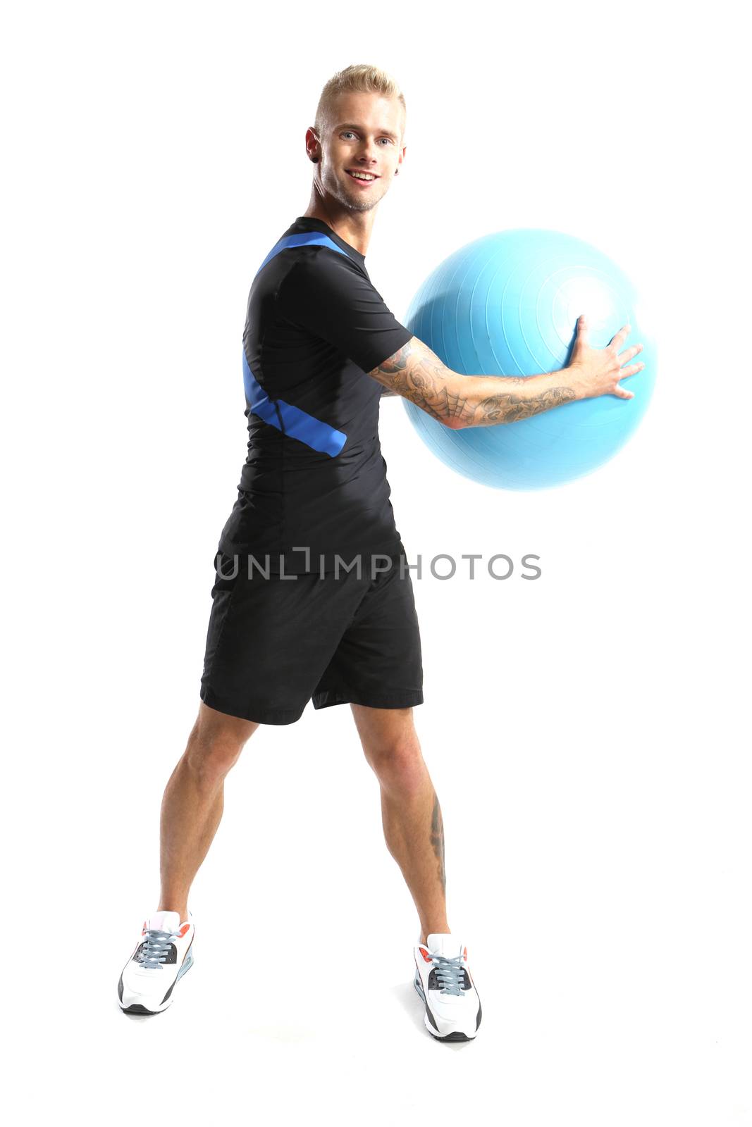 Gymnastics, man exercises on the ball