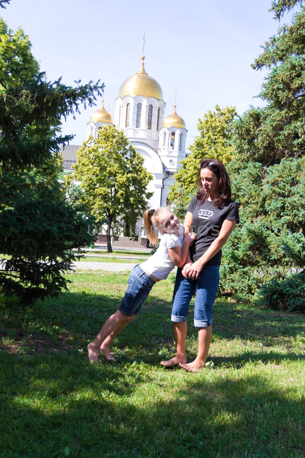 Photo of smiling playing mother and daughter