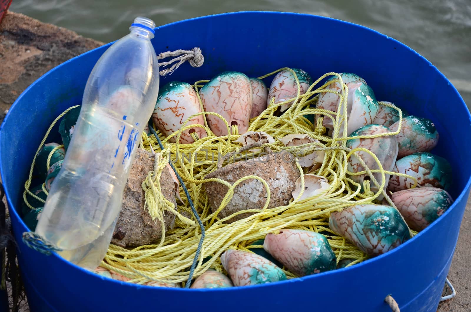 Fishing tool made by fisherman inside blue basket by pixbox77