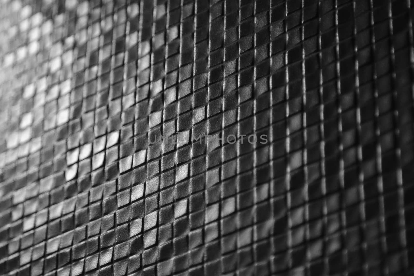 Dark tiles mosaic pattern on a wall