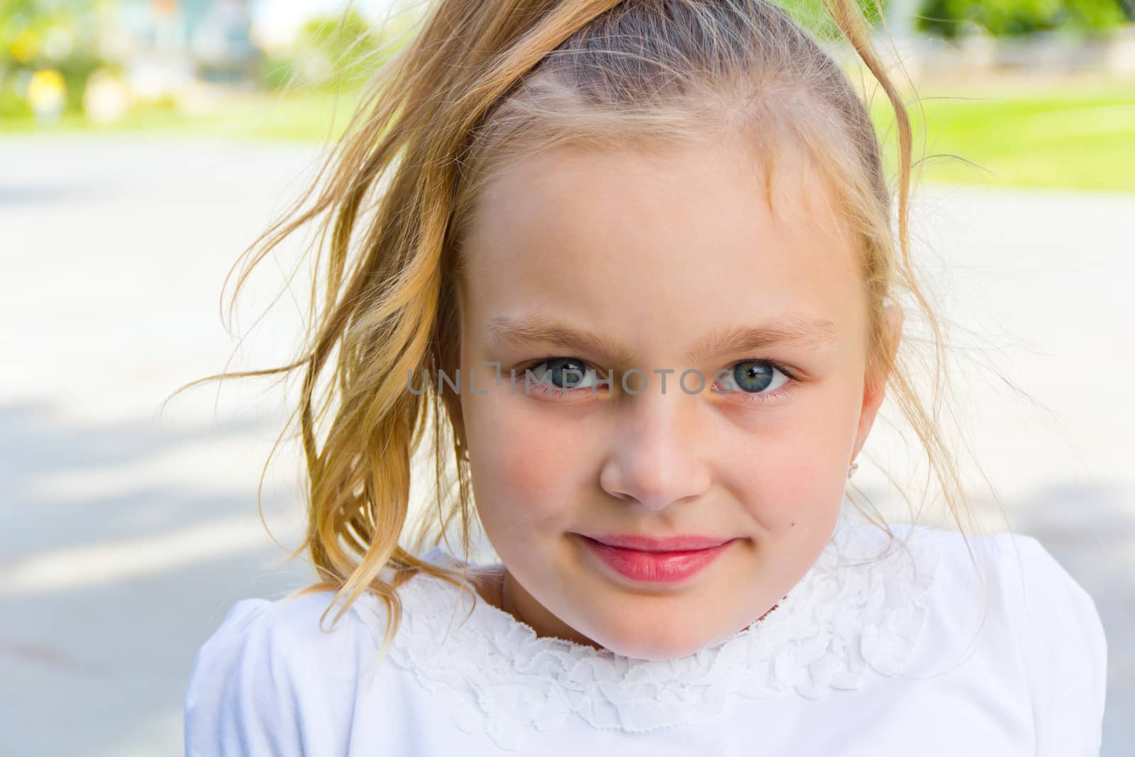 Cute girl with blond long hair and blue eyes