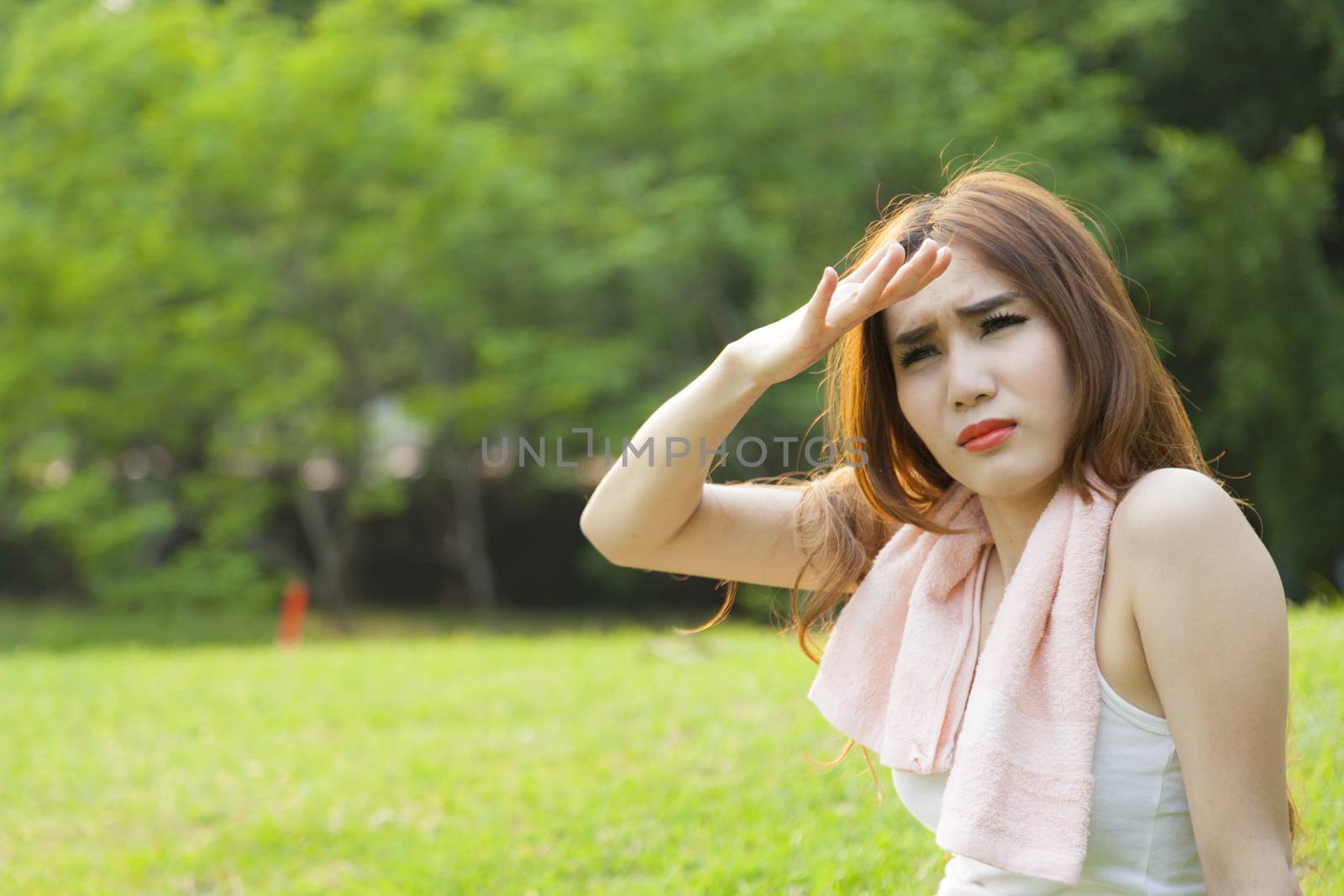 Woman sitting rest after exercise Inside the park