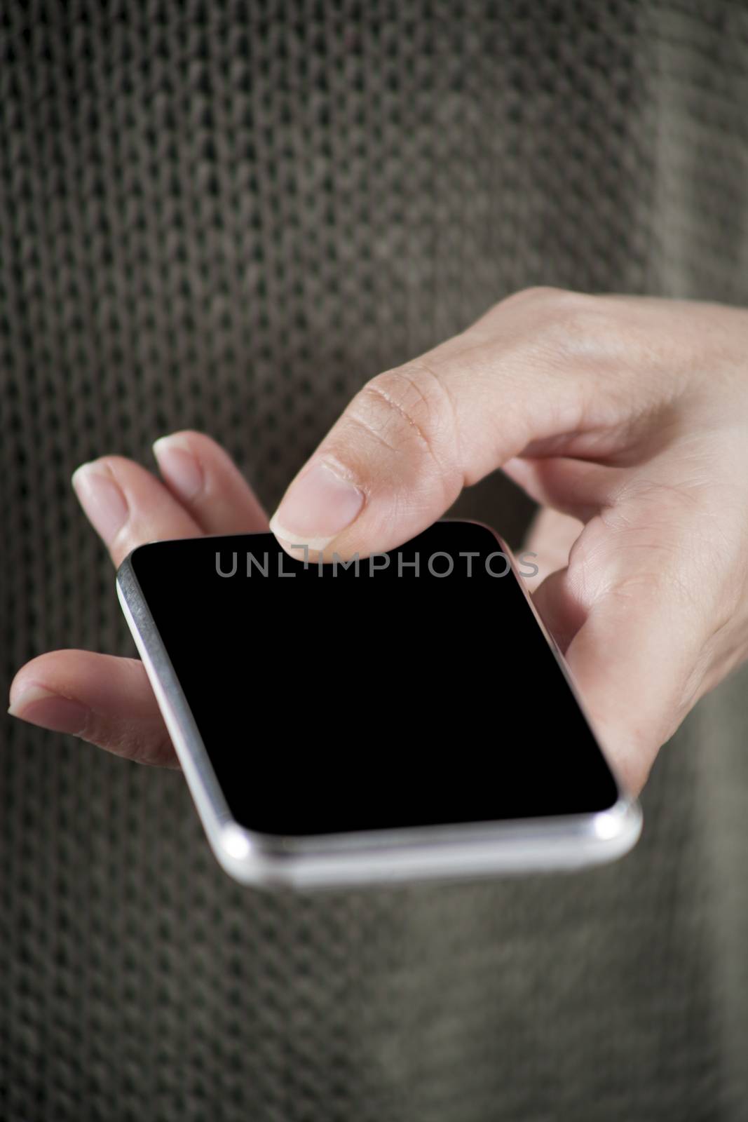 blank screen smartphone in woman hand with green jersey