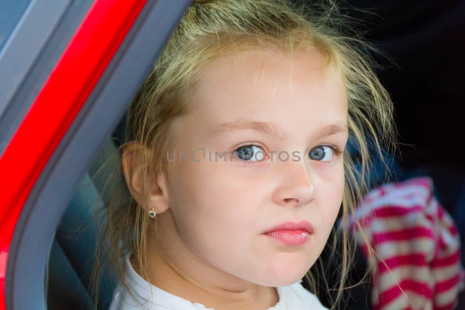 Cute girl with blond long hair and blue eyes