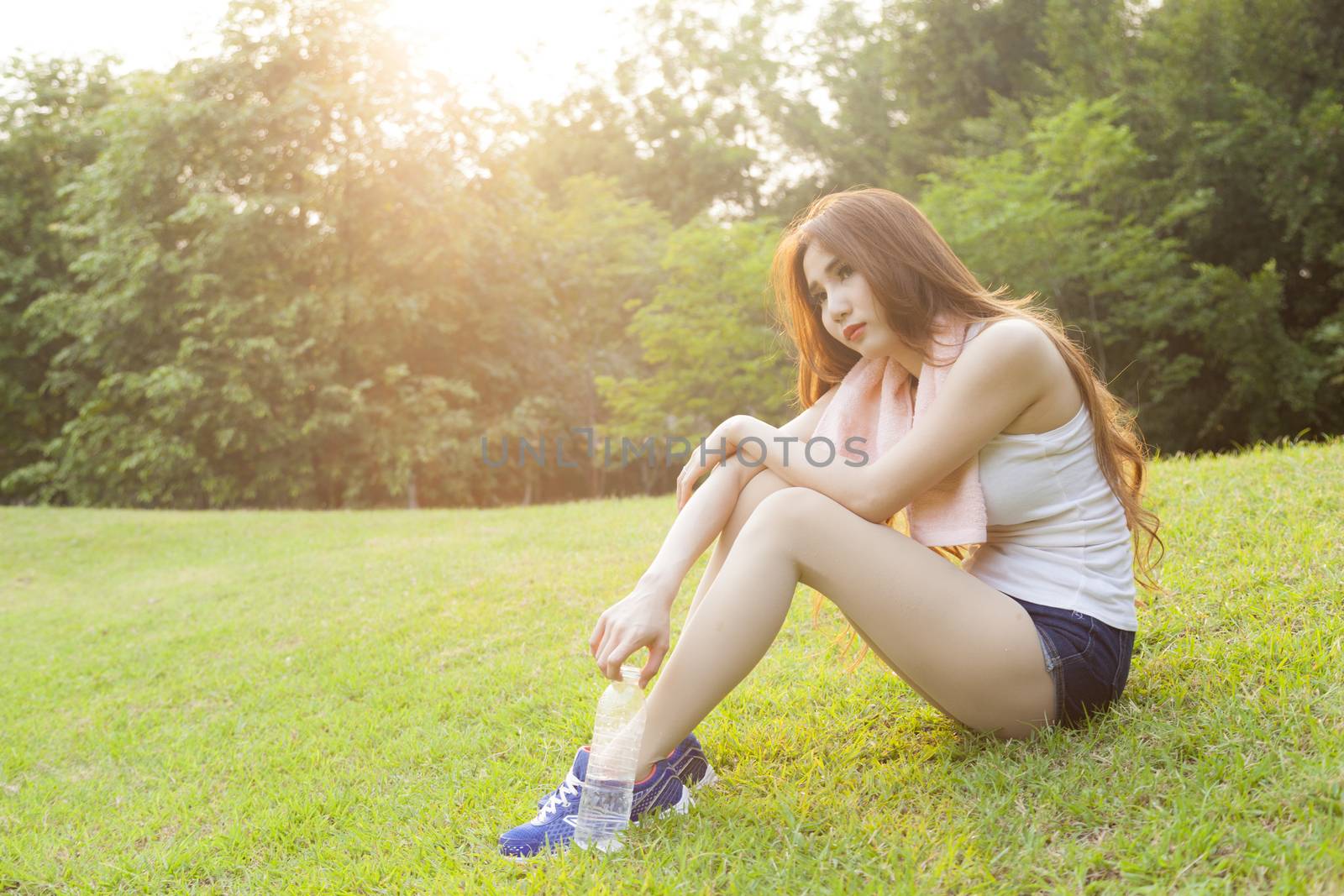 Woman sitting rest after exercise. by a454