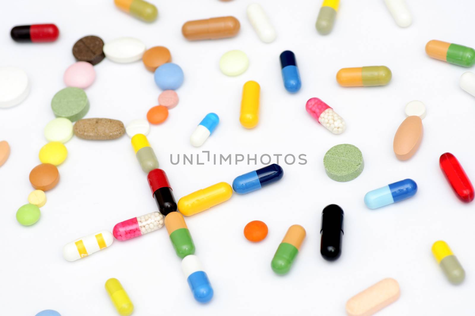 Prescription symbol Rx made of various capsules, pills and tablets