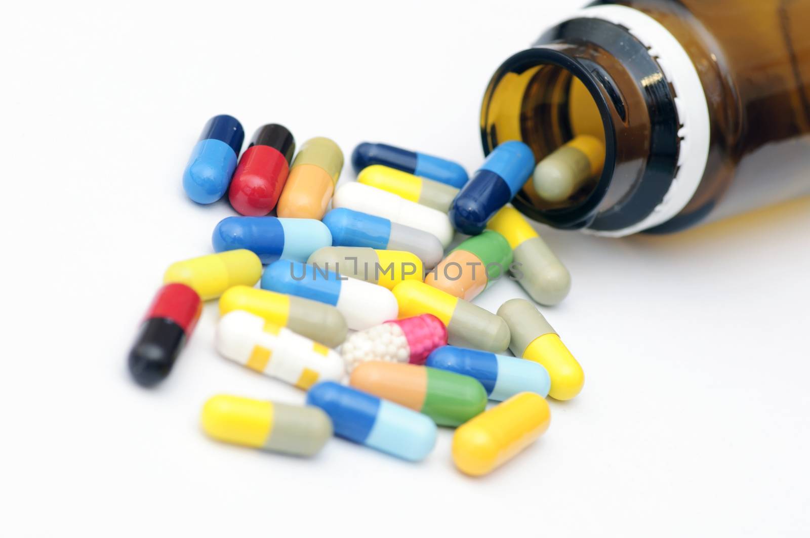 Assortment of capsules and phial on white