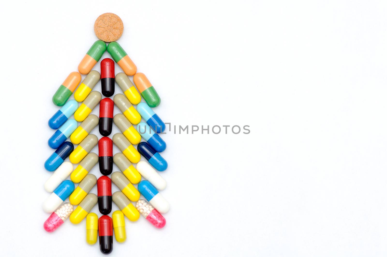 Christmas tree made of capsules on white background