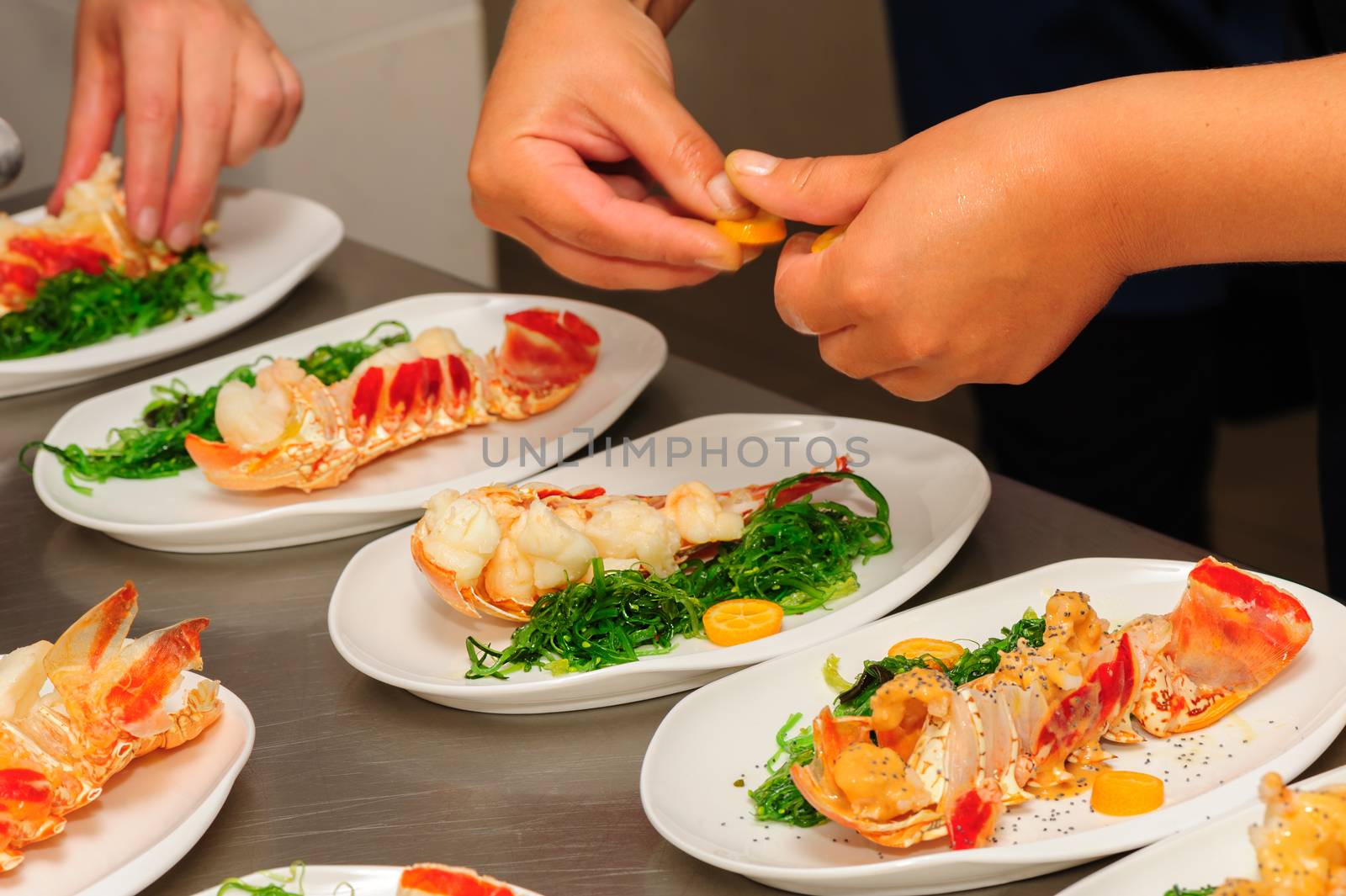 Serving and decorating of prepared lobsters on plates