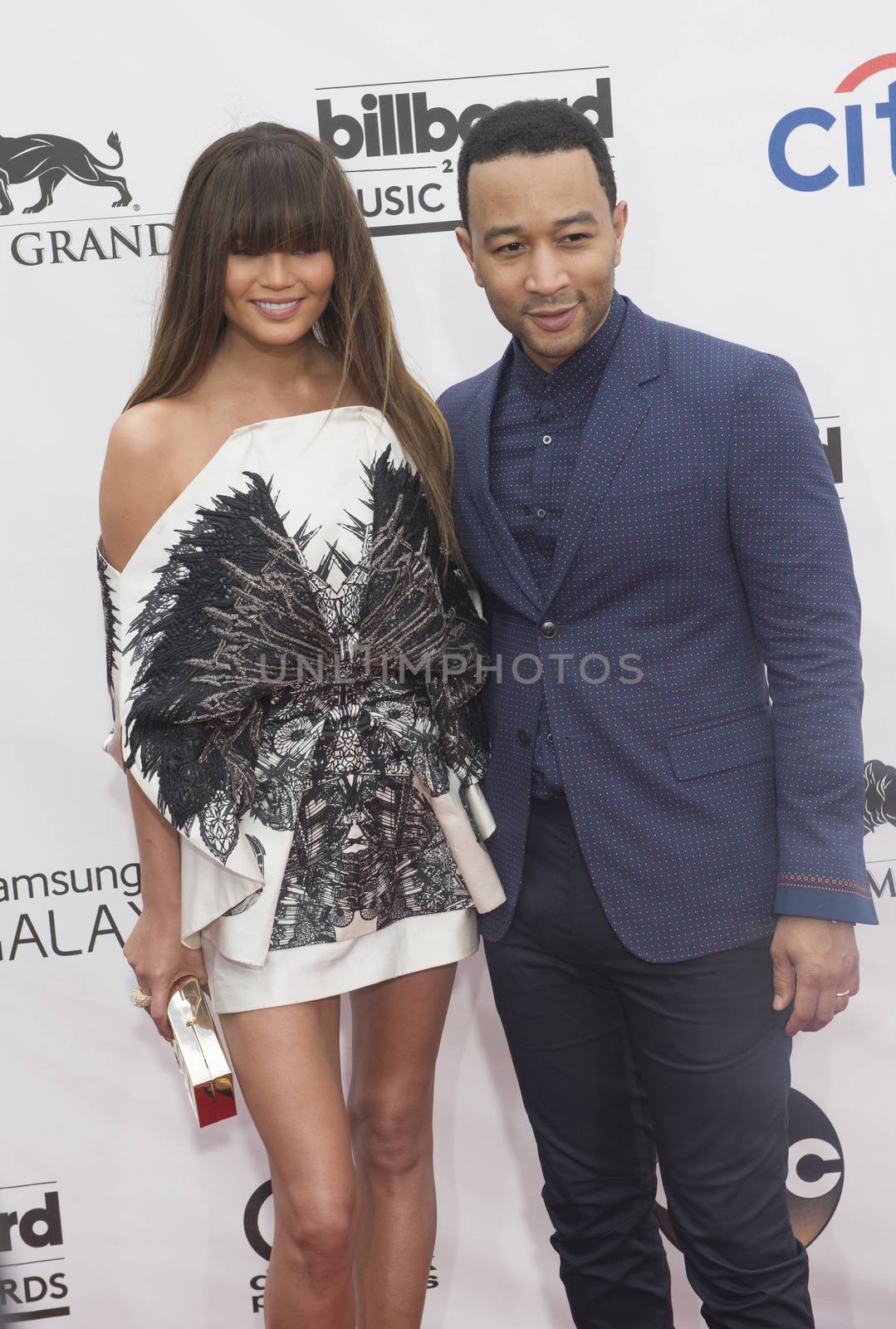 LAS VEGAS - MAY 18 : Singer/songwriter John Legend (R) and wife model Christine Teigen attend the 2014 Billboard Music Awards at the MGM Grand Garden Arena on May 18 , 2014 in Las Vegas.