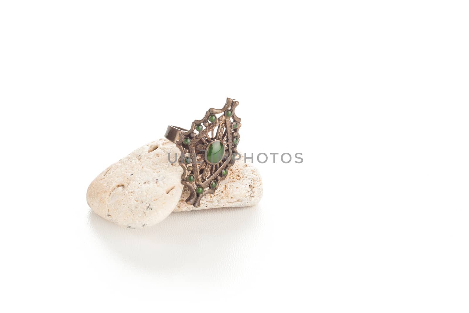 vintage metal fashion ring with green gems on rocks