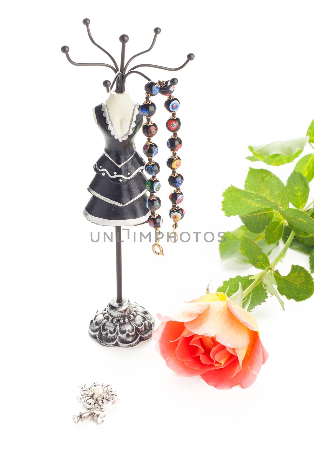 braclet on a stylish jewelry holder and a rose