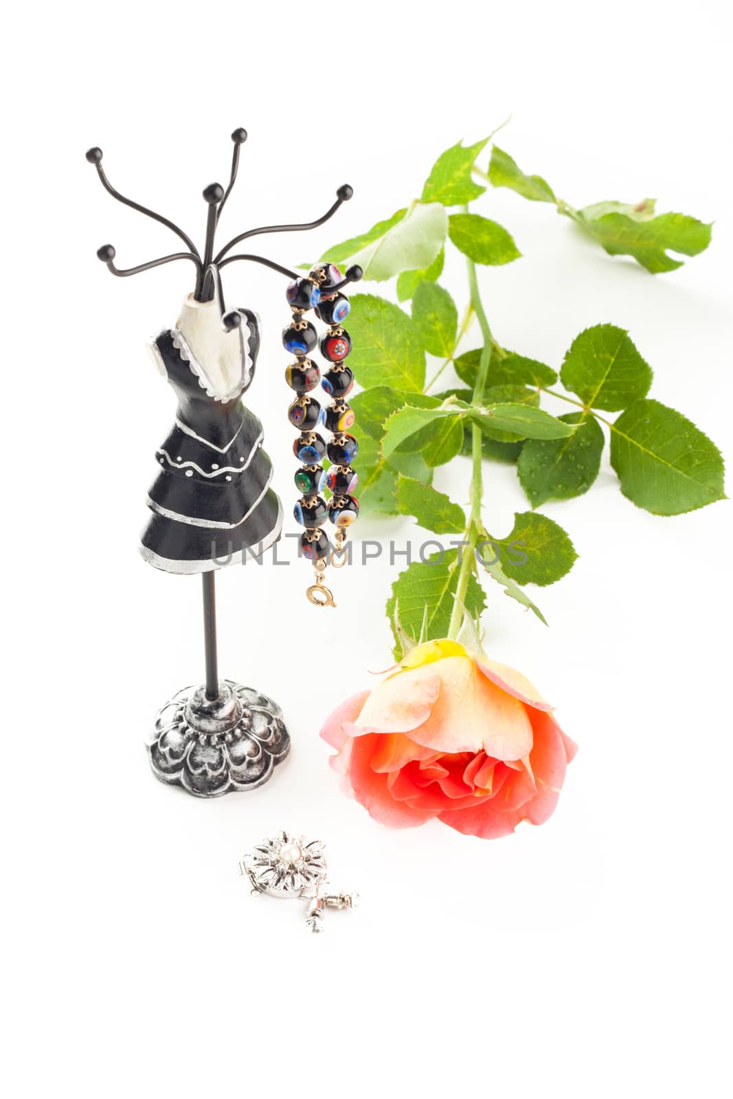 bracelet on a stylish jewelry holder and a rose