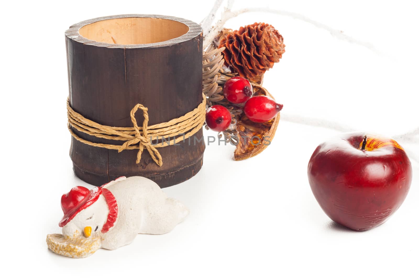 christmas setting with candle, apple, snowman and flowers