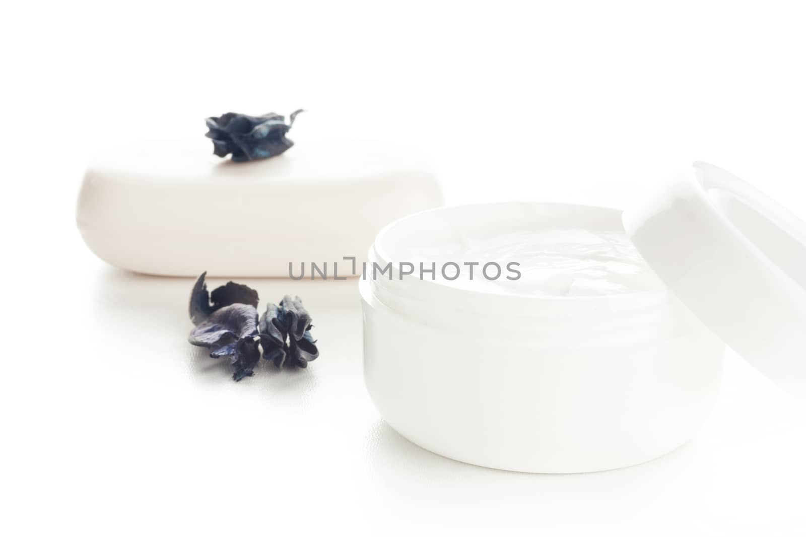 white cosmetic moisturizer cream in white container and white soap