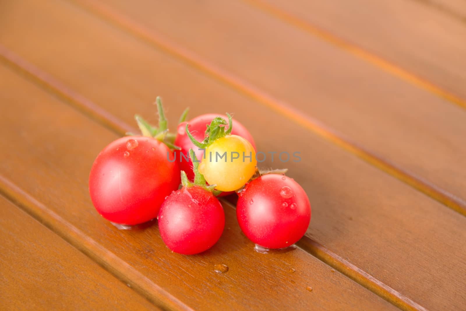 Photo shows a detail of the colourful tomatoes on a table.