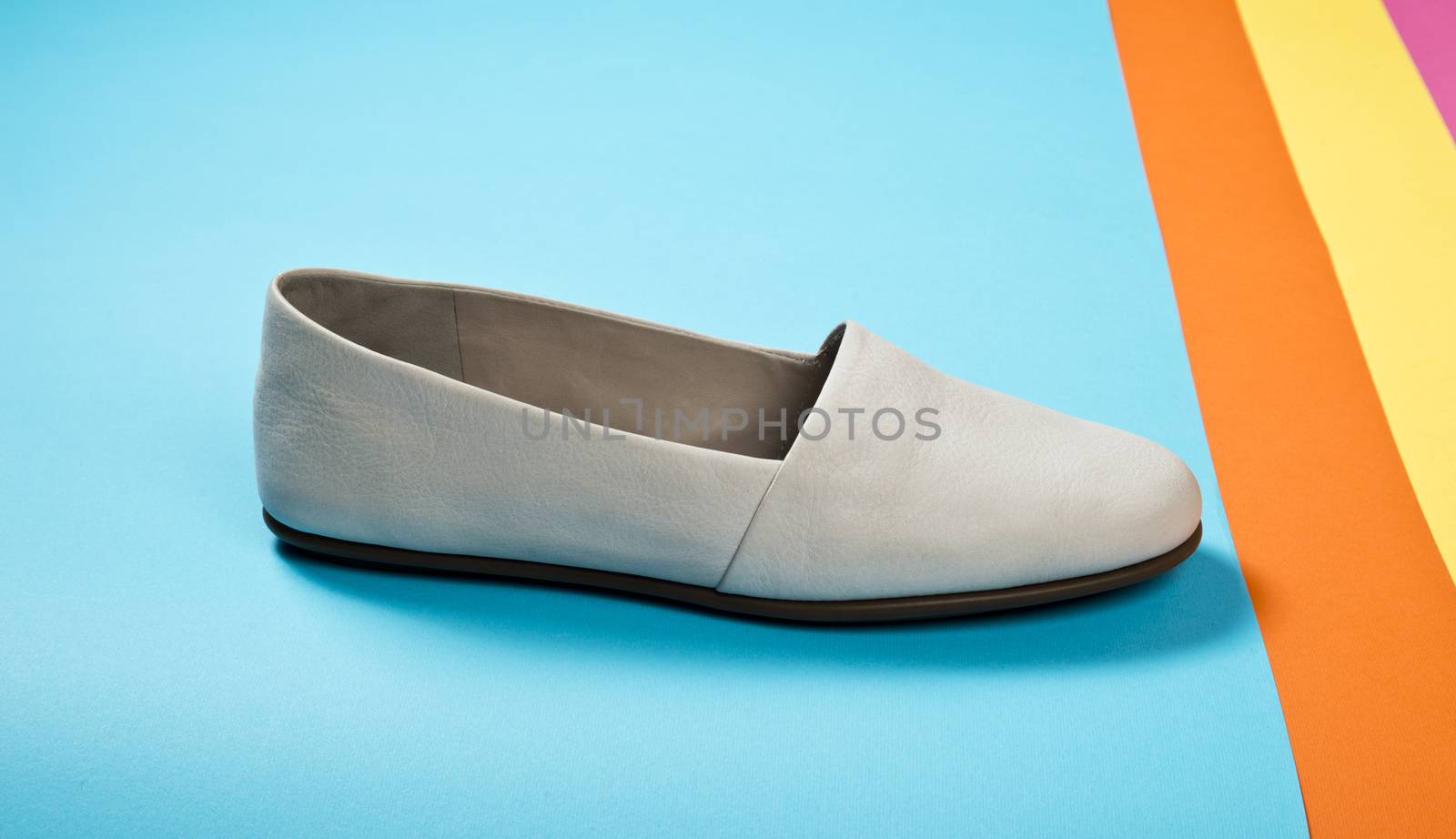 Woman casual gray leather shoes on blue