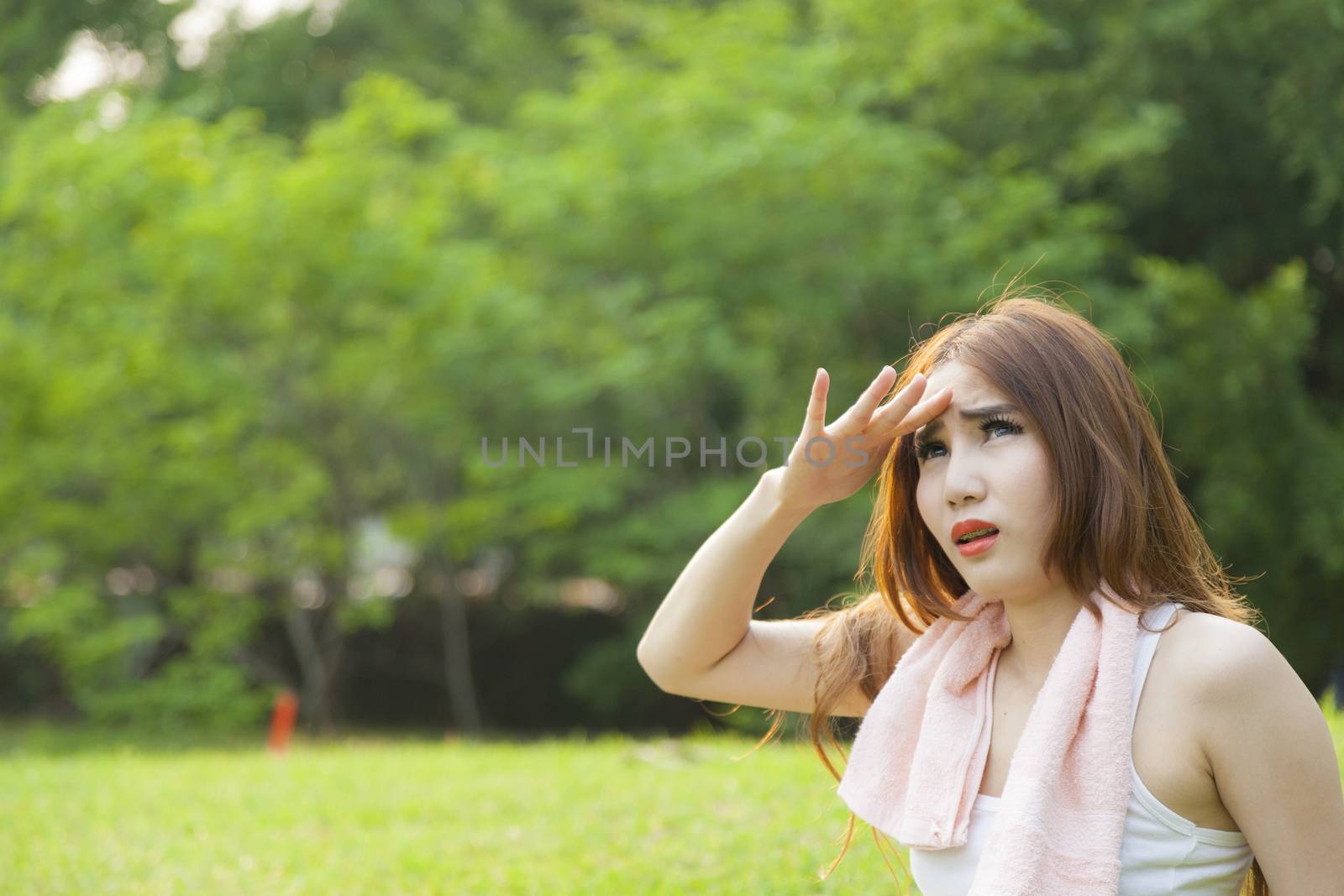 Woman sitting rest after exercise Inside the park