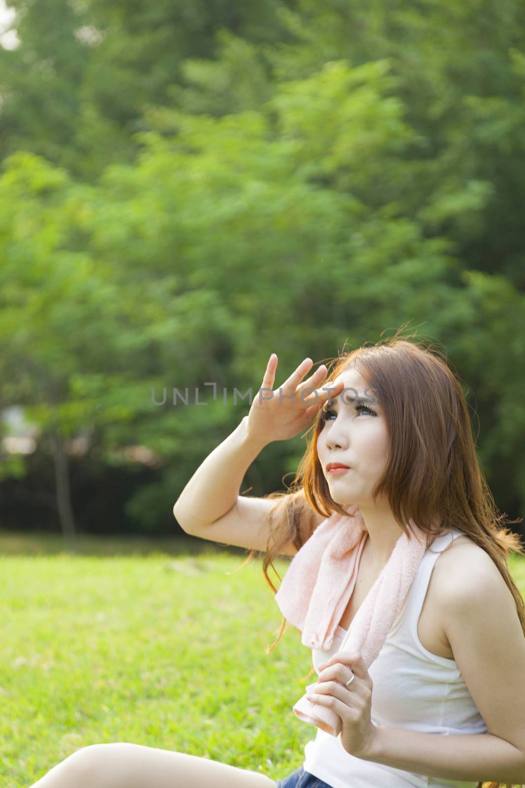 Woman sitting rest after exercise Inside the park