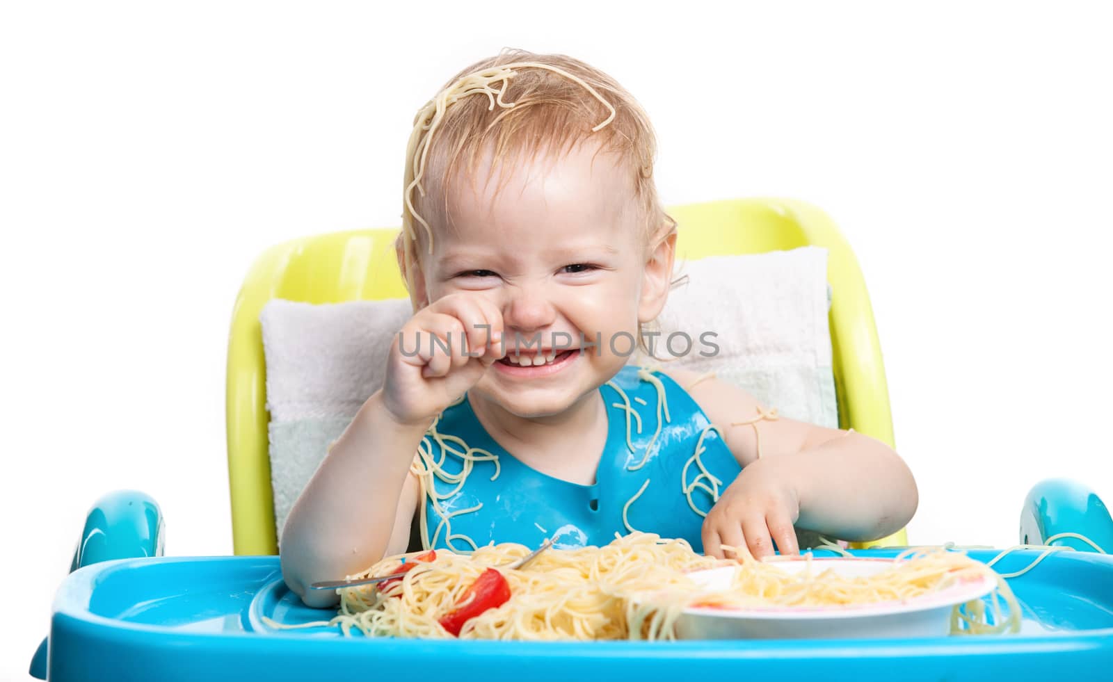 Little boy eating spaghetti and laughing by photobac