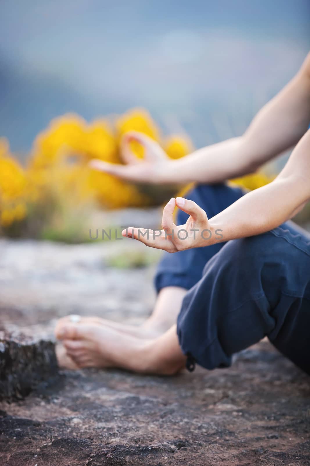 Close up of female hand zen gesturing. Girl sits in asana position.