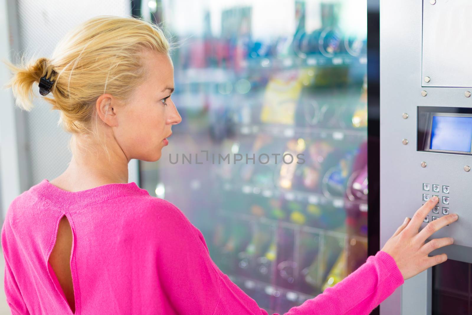 Lady using  a modern vending machine by kasto