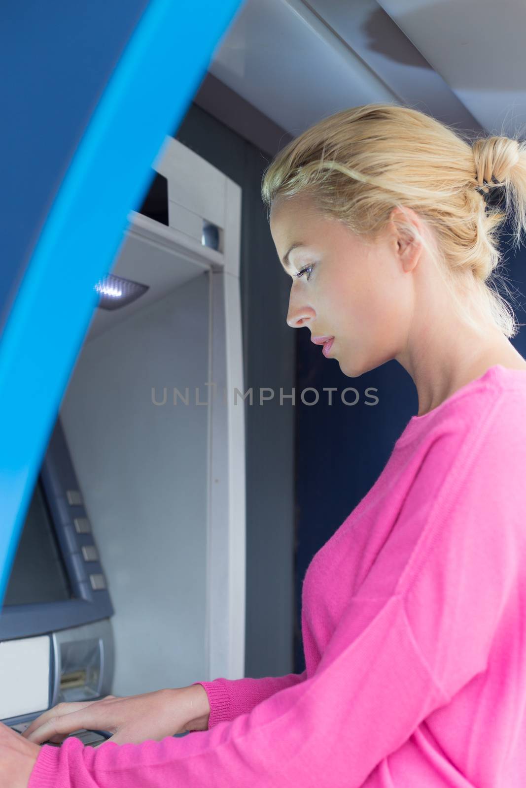 Lady using an atm counter by kasto