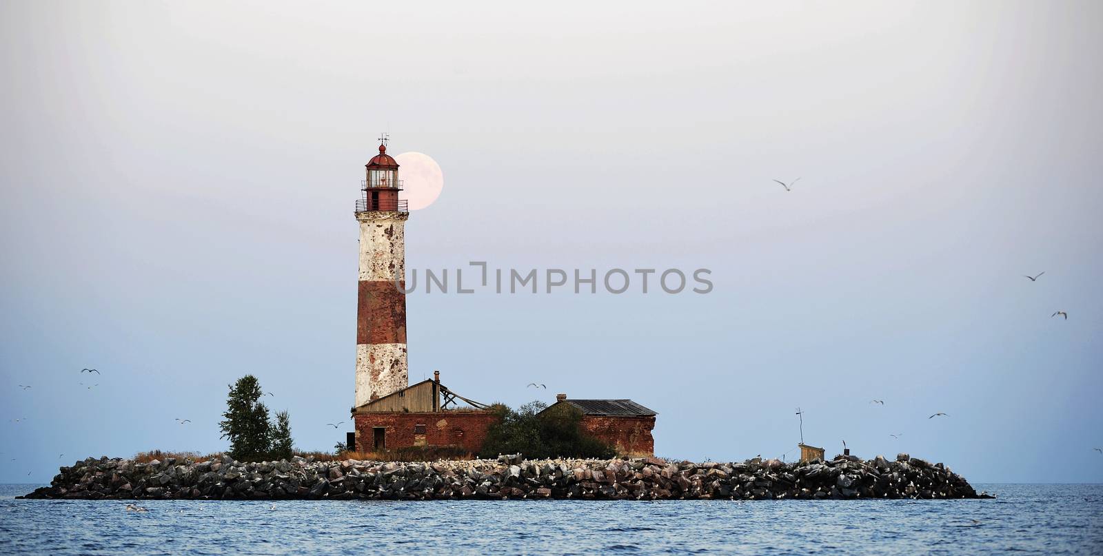 Moon and Old lighthouse of the Suho  island in Ladoga.