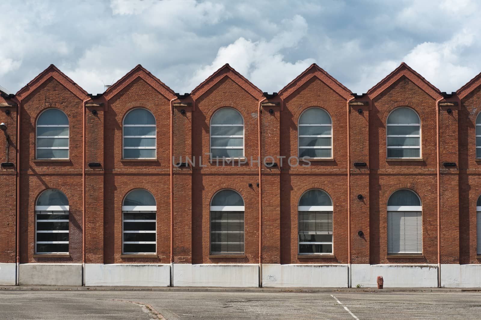 old industrial  brick facade by NeydtStock
