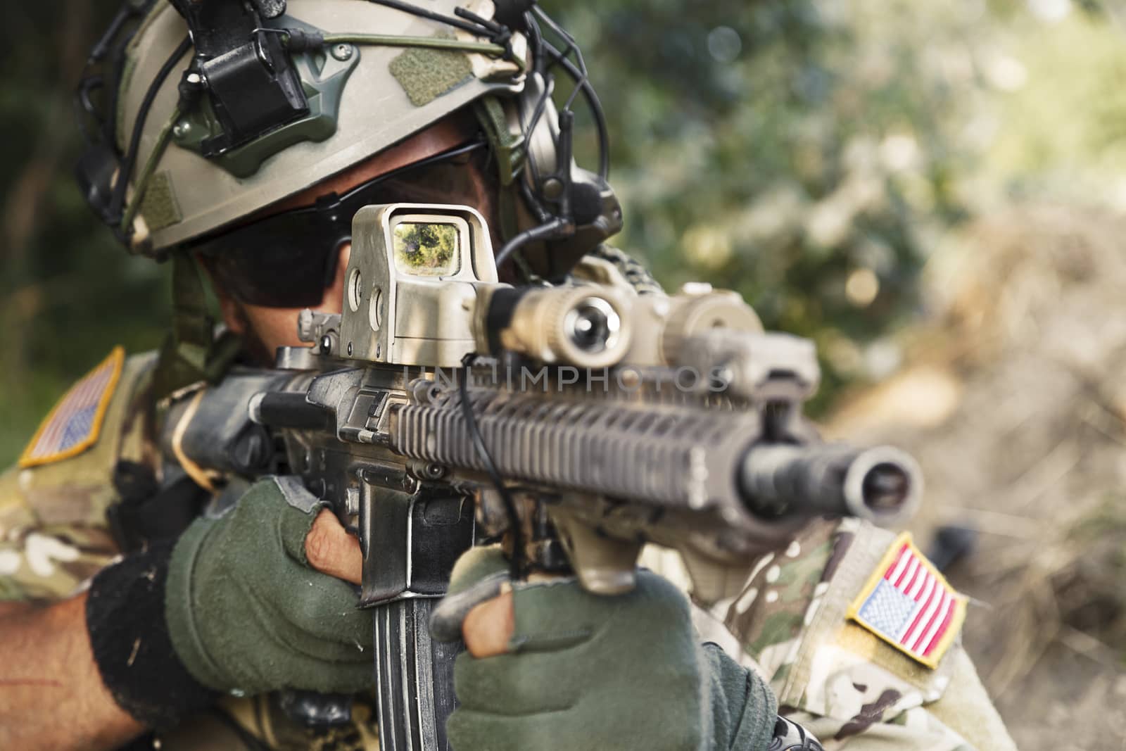 american soldier pointing hi rifle during the military operation
