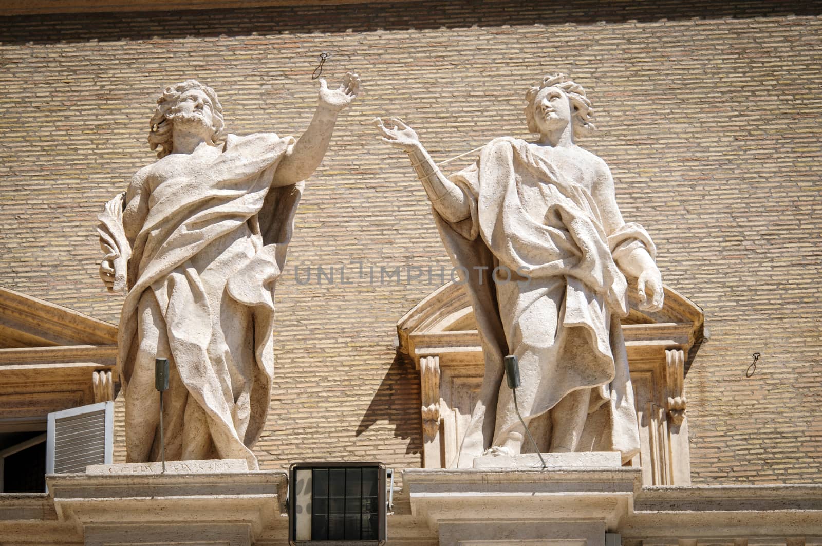 Statues on top of collonnade of St. Peters square in Rome, Italy