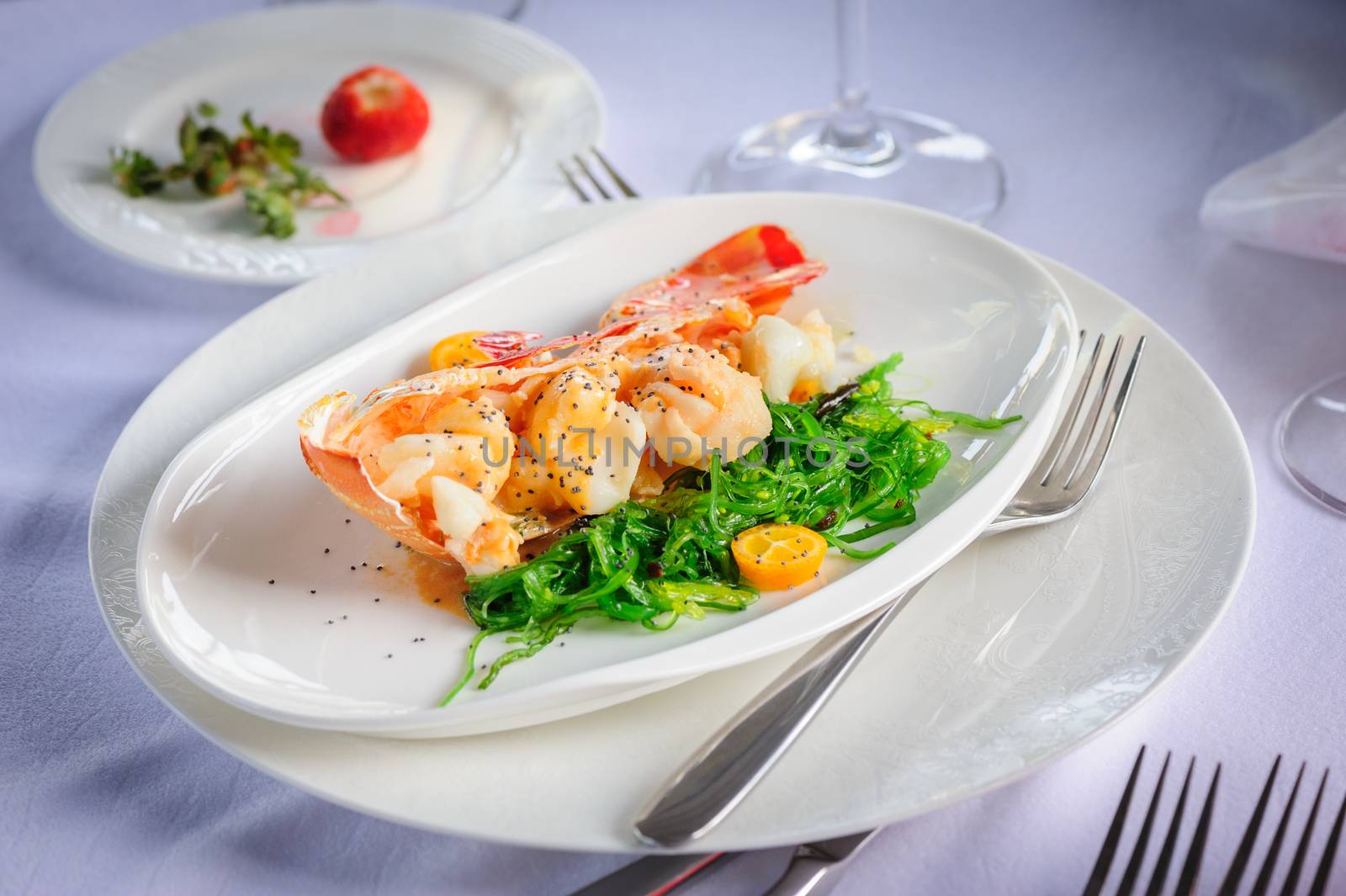 Prepared lobster and sea weed served on plates